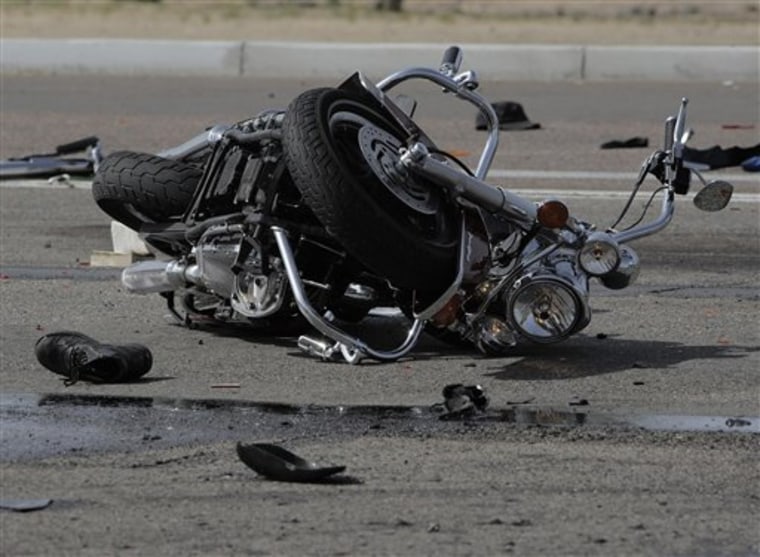 A wrecked motorcycle lies at the the scene of a multi-motorcycle and trash truck accident on the Carefree Highway in Phoenix, Ariz., March 25, 2010. Three people riding motorcycles were killed and six others critically injured when several bikes were struck by a truck hauling garbage on the Carefree Highway in north Phoenix.